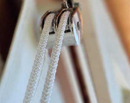 A manual rope roll-up porch enclosure.