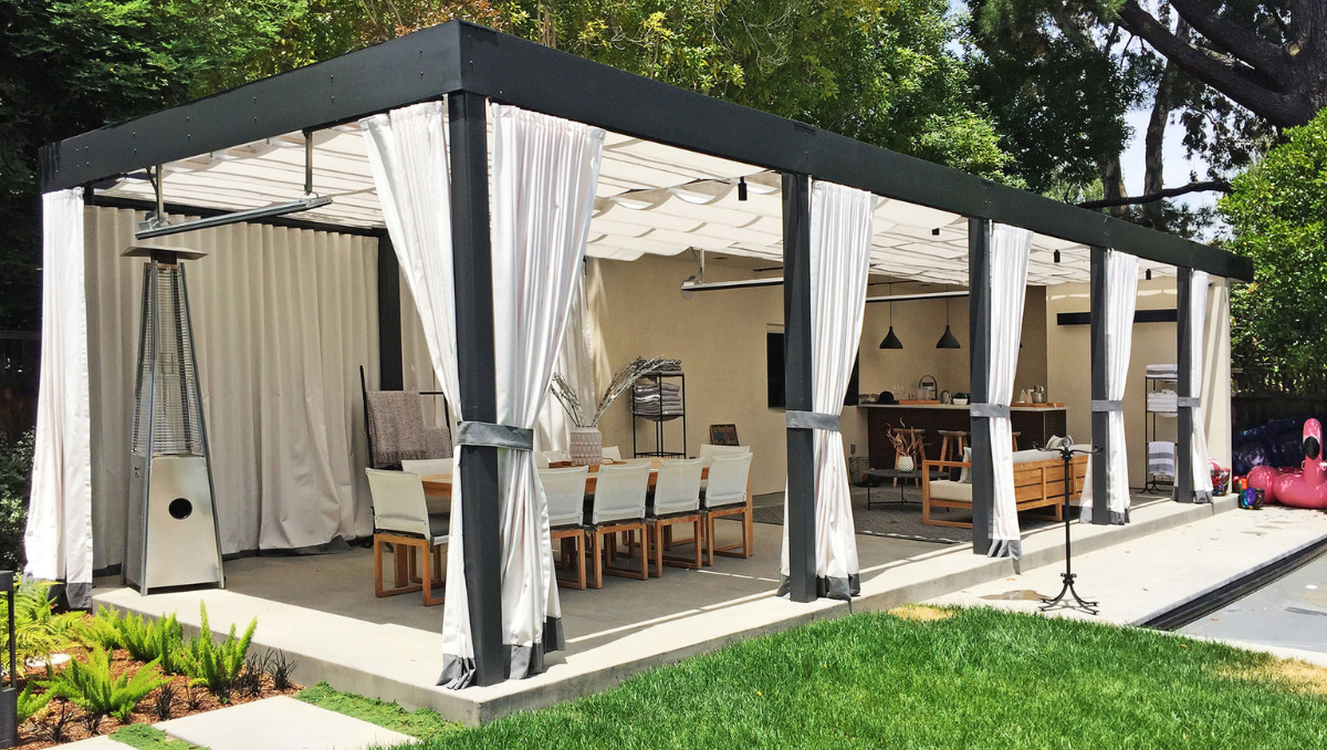 Motorized and retractable pergolas featuring retractable fabric shade canopy in modern backyard