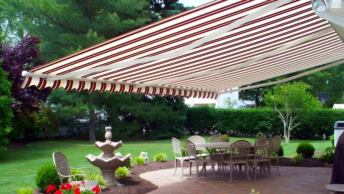 Striped retractable awning shading backyard patio in St Michaels Maryland