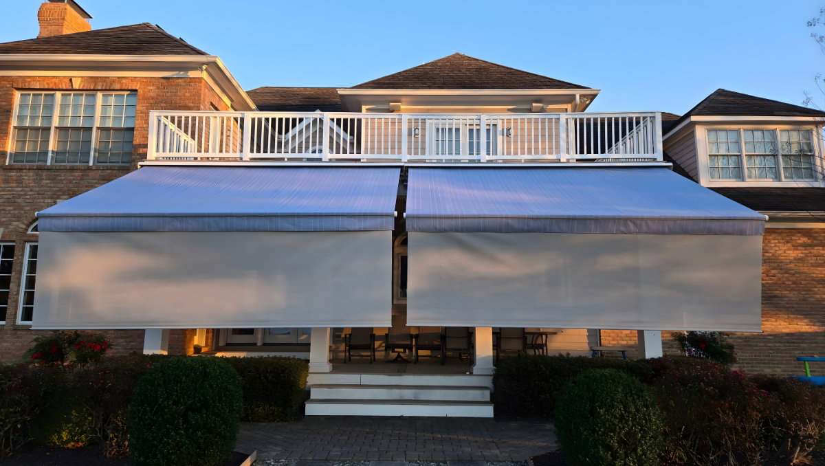 Motorized retractable awnings providing sun shade over a covered patio at a home in Centreville Maryland on the Eastern Shore