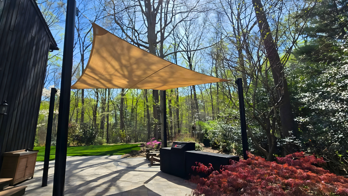Shade sail maintenance Maryland Delaware installation providing backyard patio shade in Annapolis with tensioned fabric between black powder coated steel posts