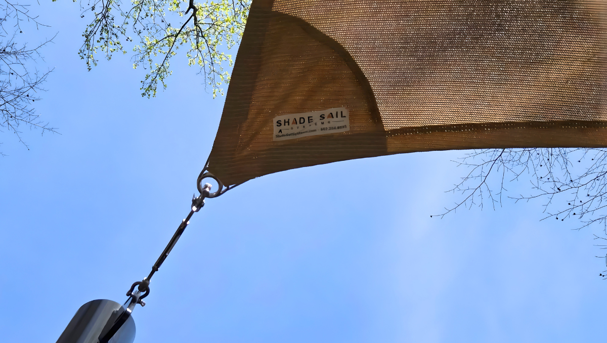 Shade sail corner detail with tension hardware and attachment point on outdoor shade structure in Maryland backyard