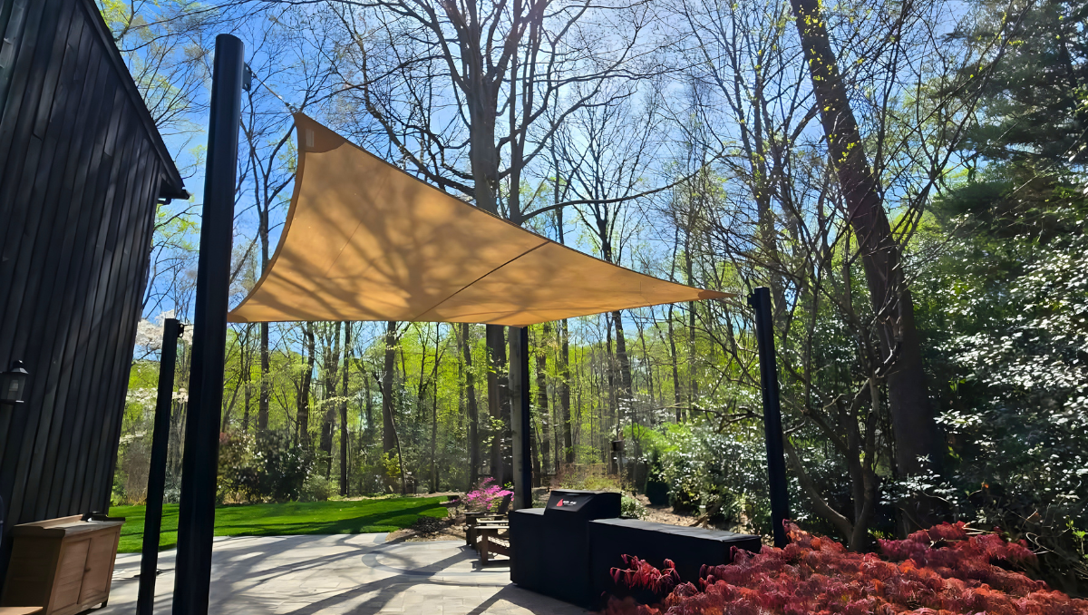 Shade sail canopy installed over a backyard patio in Annapolis MD providing sun protection and modern outdoor shade