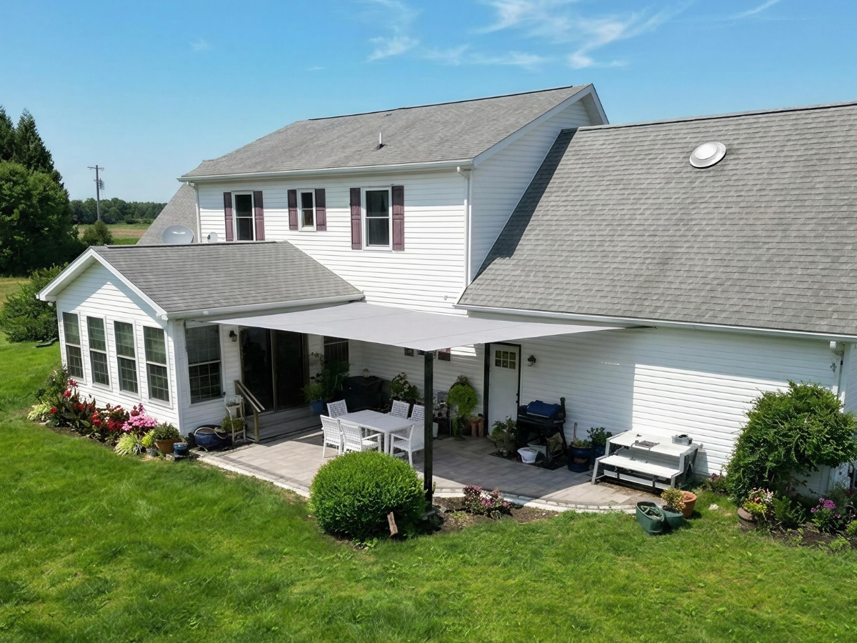 Perfect Shade Sail Installation in Delaware Finished custom shade sail installation creating comfortable shade over a residential patio on Maryland's Eastern Shore.