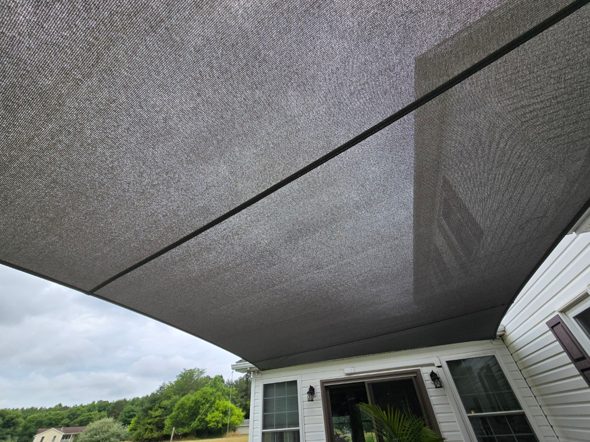 View from beneath a premium UV-resistant shade sail providing shade over a residential patio.