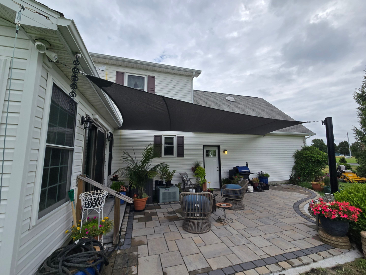 Completed custom shade sail installation with engineered steel support post in Bridgeville, Delaware.