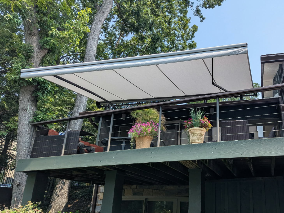 Custom retractable awning fully extended over an elevated deck in Falls Church, Virginia.