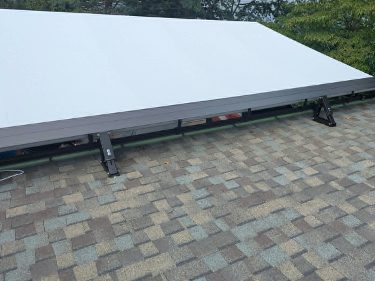 Roof-mounted brackets supporting a custom retractable awning during installation in Falls Church, Virginia.