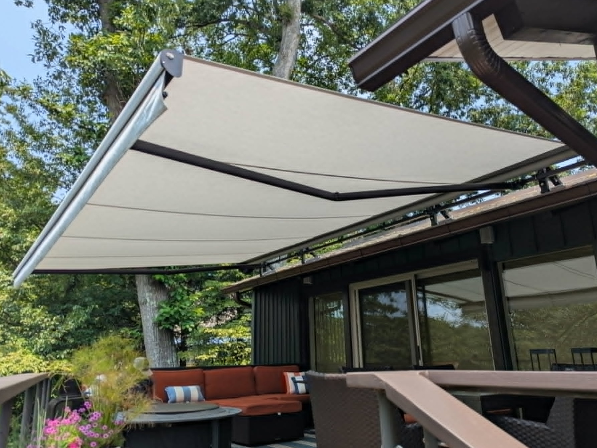 Side view of a motorized retractable awning providing shade over a residential deck in Falls Church, VA.