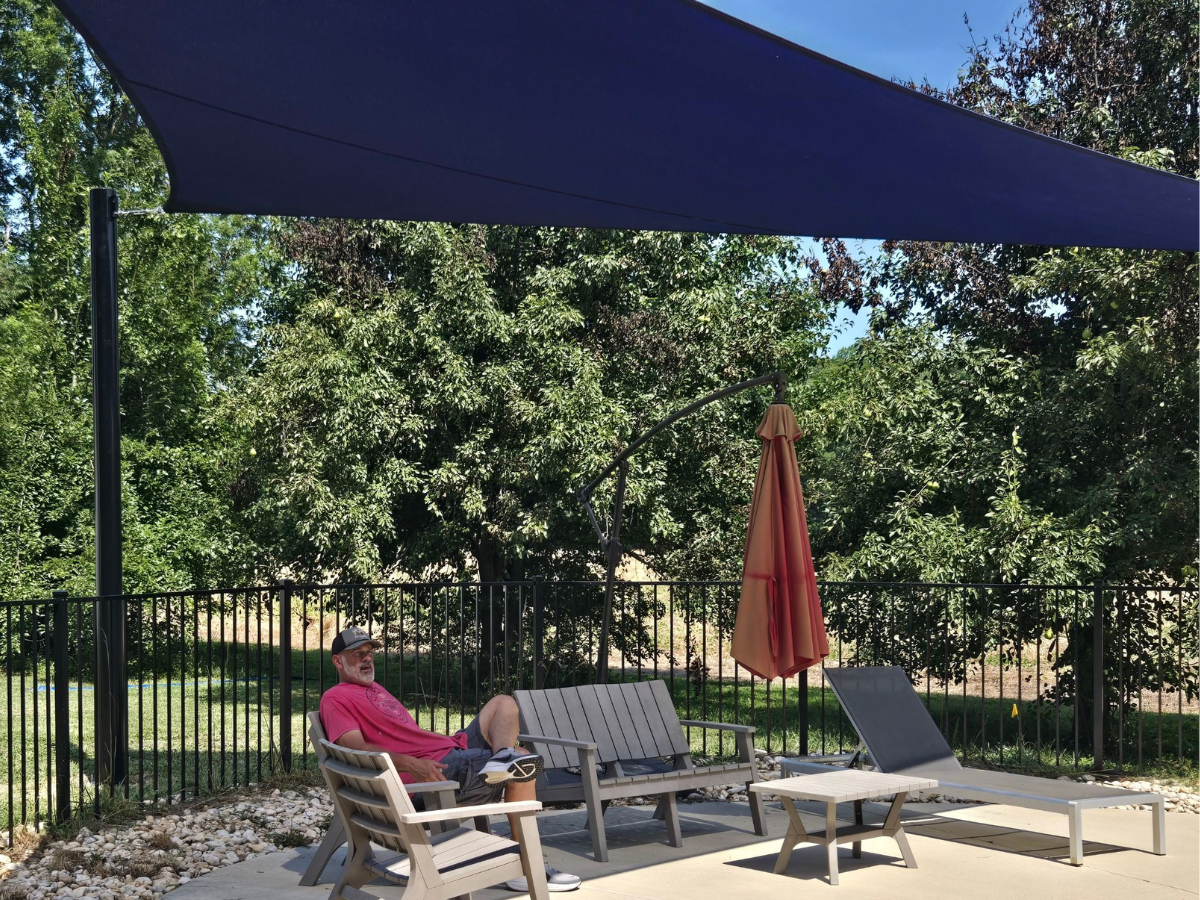 Enjoying the newly shaded poolside seating area on a sunny afternoon.