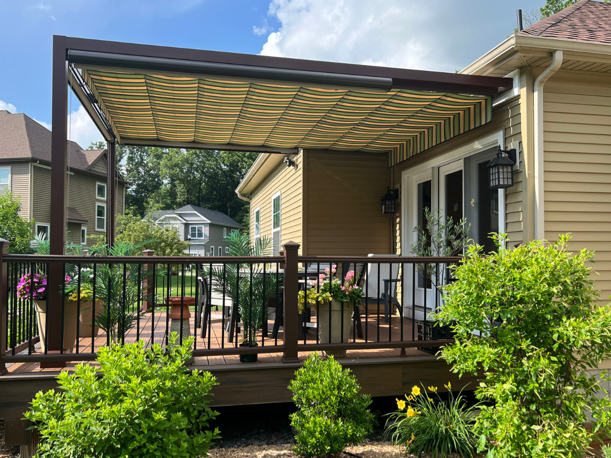 Retractable pergola providing adjustable shade over a backyard deck and outdoor dining space.