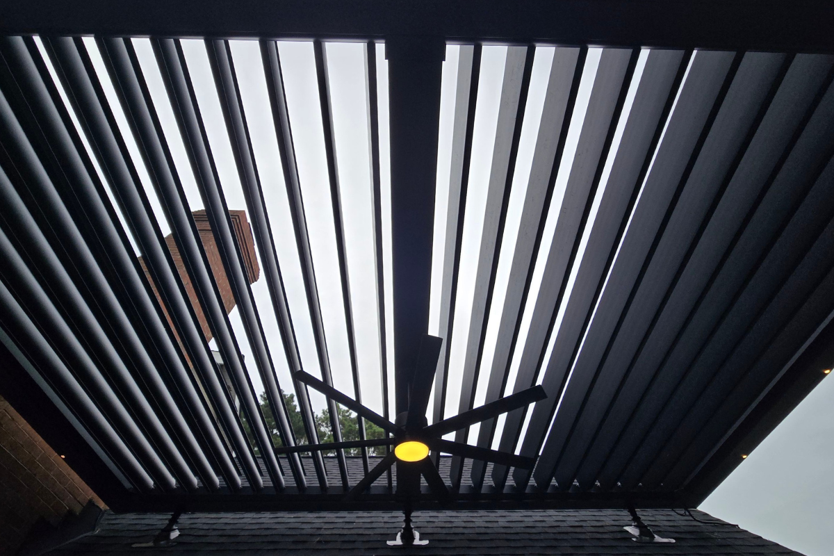 Open Motorized Pergola Louvers Open motorized pergola louvers allowing natural light and airflow onto the deck below