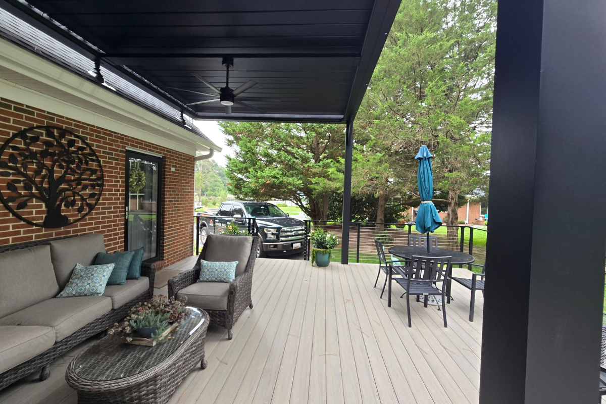 Covered Outdoor Living Space Under a Motorized Pergola Furnished deck beneath a custom motorized louvered pergola in Royal Oak, Maryland
