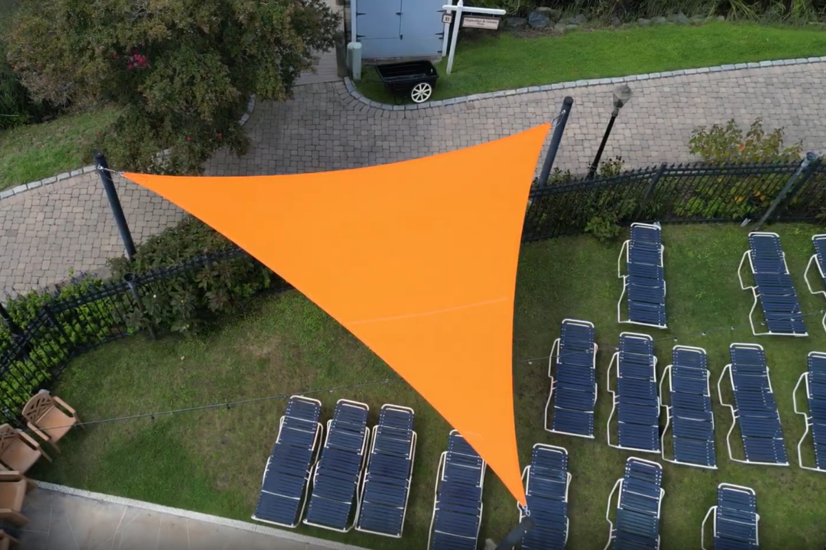 Orange commercial shade sail providing shade at Herrington Harbour South in Maryland